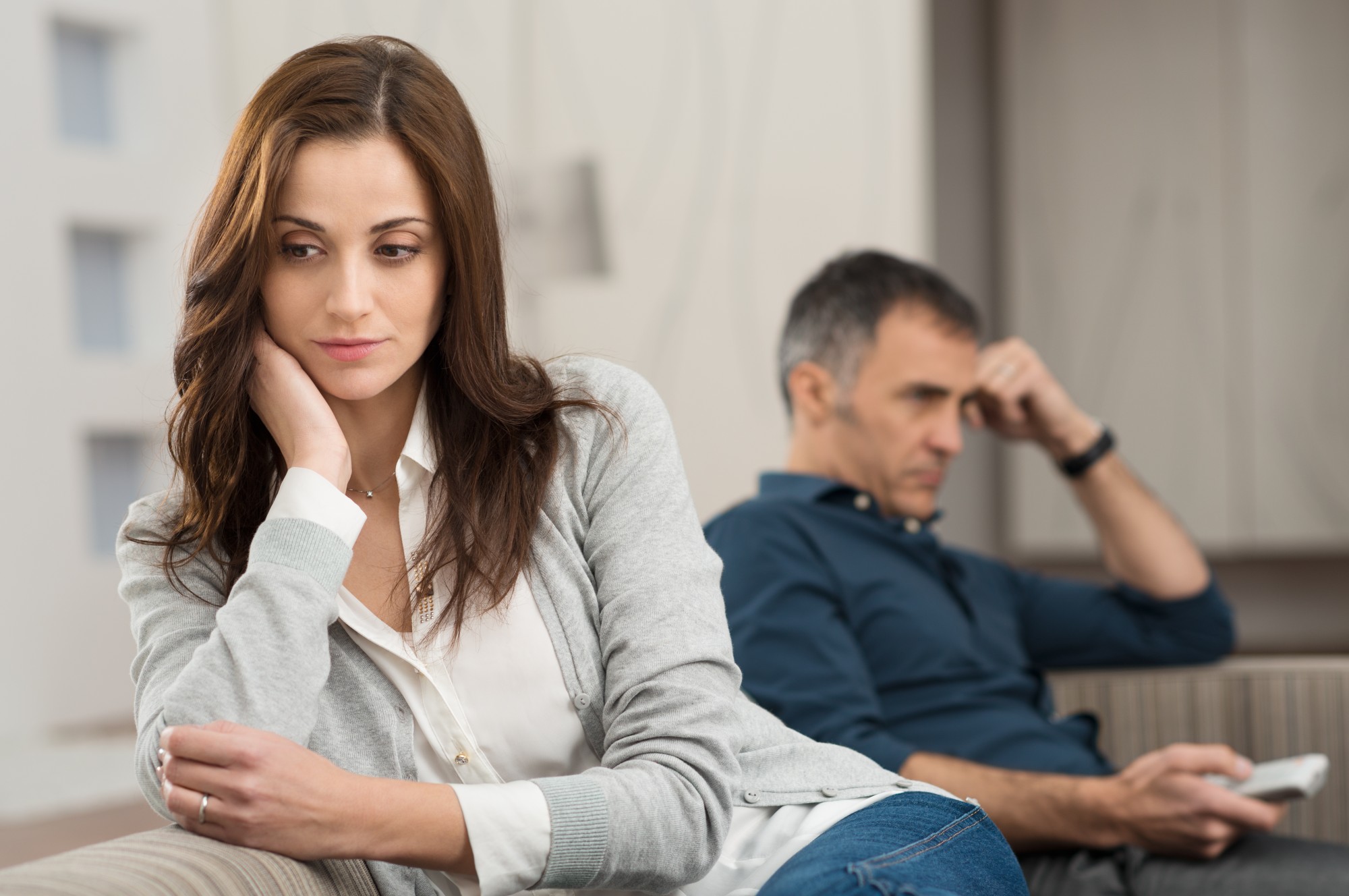 Sad Couple Sitting On Couch After Having Quarrel Main Street